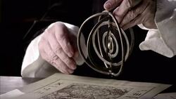 Nostradamus picks up a gyroscope and adjusts the spokes. Stock Footage