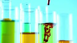 Pouring yellow liquid into Beaker Stock Footage