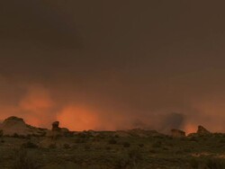 Storm clouds in distant desert canyon - wide Stock Footage
