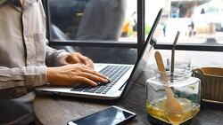 Handsome young businessman working at laptop with cup of coffee Stock Footage