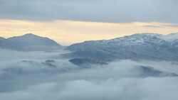 Mist over the Lake District mountains at dusk from the summit of Red Screes, Lake District National Park, Cumbria, UK Stock Footage
