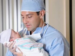 MS TU Father in Surgical Scrubs Holding Newborn Baby in Hospital / Richmond, Virginia, USA Stock Footage