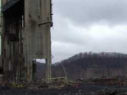 WS Tall building at old power plant is demolished using explosives -  and explodes in  cloud of black dust / Weirton, West Virginia, USA Stock Footage