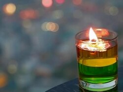 Candle on colorful lights background Stock Footage