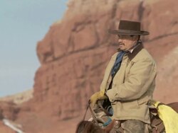 MS Cowgirl on horseback rides up hilltop to waiting cowboy on horseback / Shell, Wyoming, United States Stock Footage