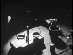 Scales tip in a dimly lit room. News Clip