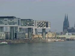 MS Ship moving on river in front of Cologne Cathedral with three Cranehouses / Cologne, North Rhine-Westphalia, Germany Stock Footage