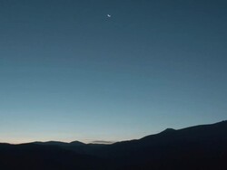 Clouds over mountains at twilight Stock Footage