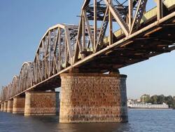 railroad bridge with train crossing Stock Footage