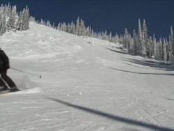 MS skiers and snowboarder make way down groomed run / nelson, british columbia, canada Stock Footage