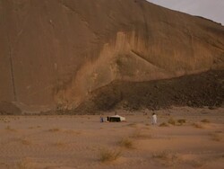 Man walking to a tent at Ben Amera monolith Stock Footage