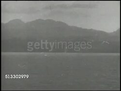 1943: BOUGAINVILLE CAMPAIGN:  BRIEF MS Rear Admiral Aaron S. Merrill (unconfirmed, 1890-1961) on deck w/ binoculars. VS U.S. Navy battleships firing artillery cannons offshore of Bougainville island. WWII, Pacific Front, Battle of Empress Augusta Bay Instructional Video