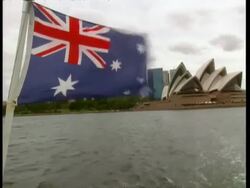 MS POV from back of boat, Australian flag flapping as boat moves away from Sydney Opera House Stock Footage
