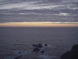 WS PAN View of Pink and purple clouds moving over ocean along coast / Big Sur, California, United States Stock Footage