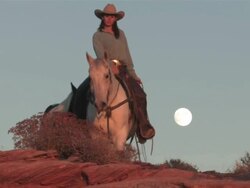 MS ZO Women Riding Horses through Majestic Red Rock Mountains with full moon / Telluride, Colorado, United States  Stock Footage