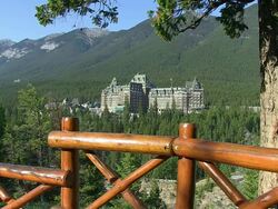 MS View of Banff Springs Hotel surrounded by tree near Bow River / Banff Nationalpark, Alberta, Canada Stock Footage