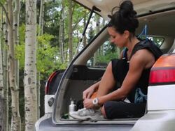 Hispanic woman in car preparing for run Stock Footage