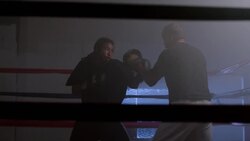 A boxer practices with his coach in boxing ring. Stock Footage