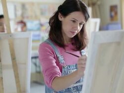 Female students painting in art class Stock Footage
