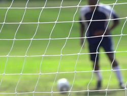 A man playing soccer on a grassy field. - Slow Motion - filmed at 240 fps Stock Footage