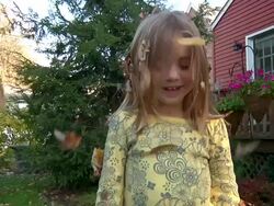 Leaves falling on little girls head 001 720p30 Stock Footage