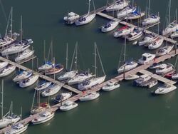 Aerial wide shot pan small boats docked in Cork Harbour / Cork, Ireland Stock Footage