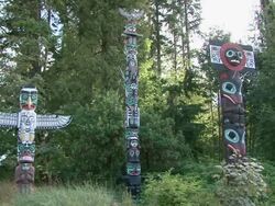 WS PAN Group of painted totem poles with trees in stanley park / Vancouver, British Columbia, Canada  Stock Footage