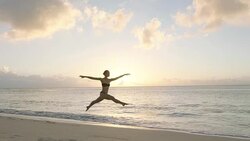 Ballet dancer jumping against sunset Stock Footage