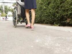 Young caregiver take care old woman on wheelchair Stock Footage