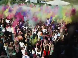 crowd of people throwing colored powder in the air Stock Footage