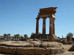Agrigento, in the foreground a circular altar of the sanctuary of the Cathonic Divinities, in the background the temple of Castor and Pollux Stock Footage