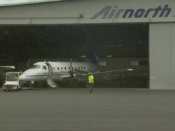 Embraer 120 Brasilia being towed out of hangar, Australia Stock Footage