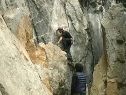 A Japanese rock climber and belayer work together Stock Footage