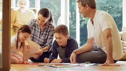 Family coloring on living room floor Stock Footage