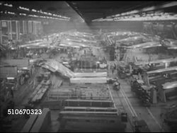 1950: BOEING FACTORY: HA WS Factory floor w/ B-47 Stratojets in lines, supplies, parts FG. BEHIND Three men in suits watching wing attaching. HA WS Crews working on swept-back wings of B-47 Stratojet medium bomber. USAF Strategic Air Command, aircraft Instructional Video
