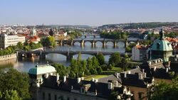 Ferryboats navigate through bridge arches on the Vltava River in downtown Prague. Stock Footage