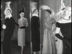 Models wearing new 1947 fashions pose in front of mirrors. Stock Footage