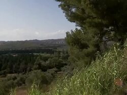 Grasses sway on a hill above a pretty French countryside. Stock Footage