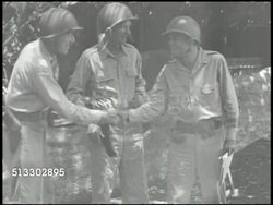1942: PACIFIC THEATER: GUADALCANAL: Change of command, three unidentified officers shaking hands, MS Unidentified officer strapping helmet, MS Second unidentified officer w/ hand on hips, three saluting.   Note: Date not confirmed.  WWII, World War II. Instructional Video