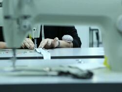 Female tailor working on sewing machine in factory Stock Footage