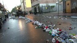 A city maintenance vehicle scoops trash off a street in New Orleans. Stock Footage