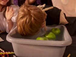 HD: Boy Bobbing For Apple At Halloween Party Stock Footage