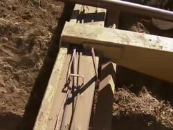 Close up of the combine's track as it gathers potatoes from the ground. Stock Footage