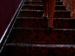 Woman descending hotel staircase Stock Footage