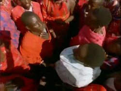 MCU aerial view of Masai tribesmen performing ritual, Kenya Stock Footage