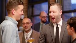 MS Smiling friends talking and having drinks together at dinner party Stock Footage