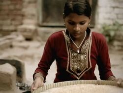 Real people from rural India: Teenage girl winnowing wheat grains. Stock Footage