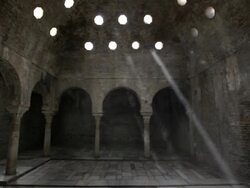 W/S dolly track archs, columns, cellar windows, rays of light, ancient islamic architecture Stock Footage