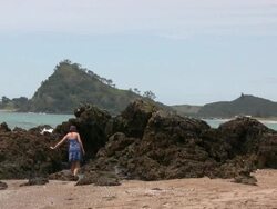 (HD1080i) Climbing Volcanic Rocks on Remote Beach Stock Footage