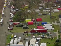 September 12, 2005 aerial vehicles and tents set up at Aurora Gardens relief camp / New Orleans, Louisiana Stock Footage